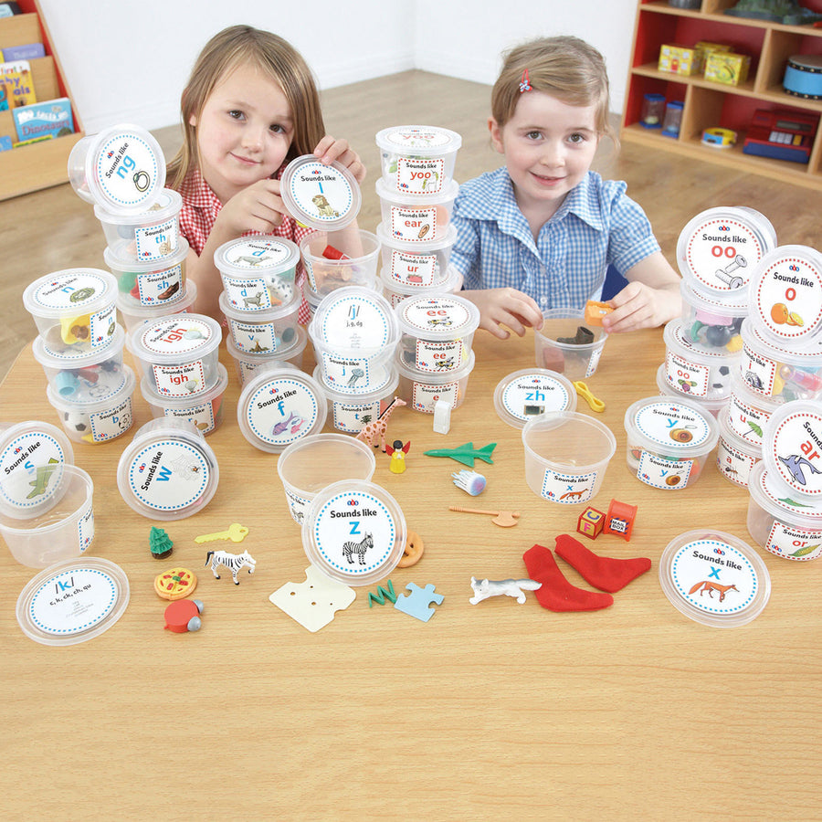 Children interacting with 44 Sound and Spelling Phonics Tubs