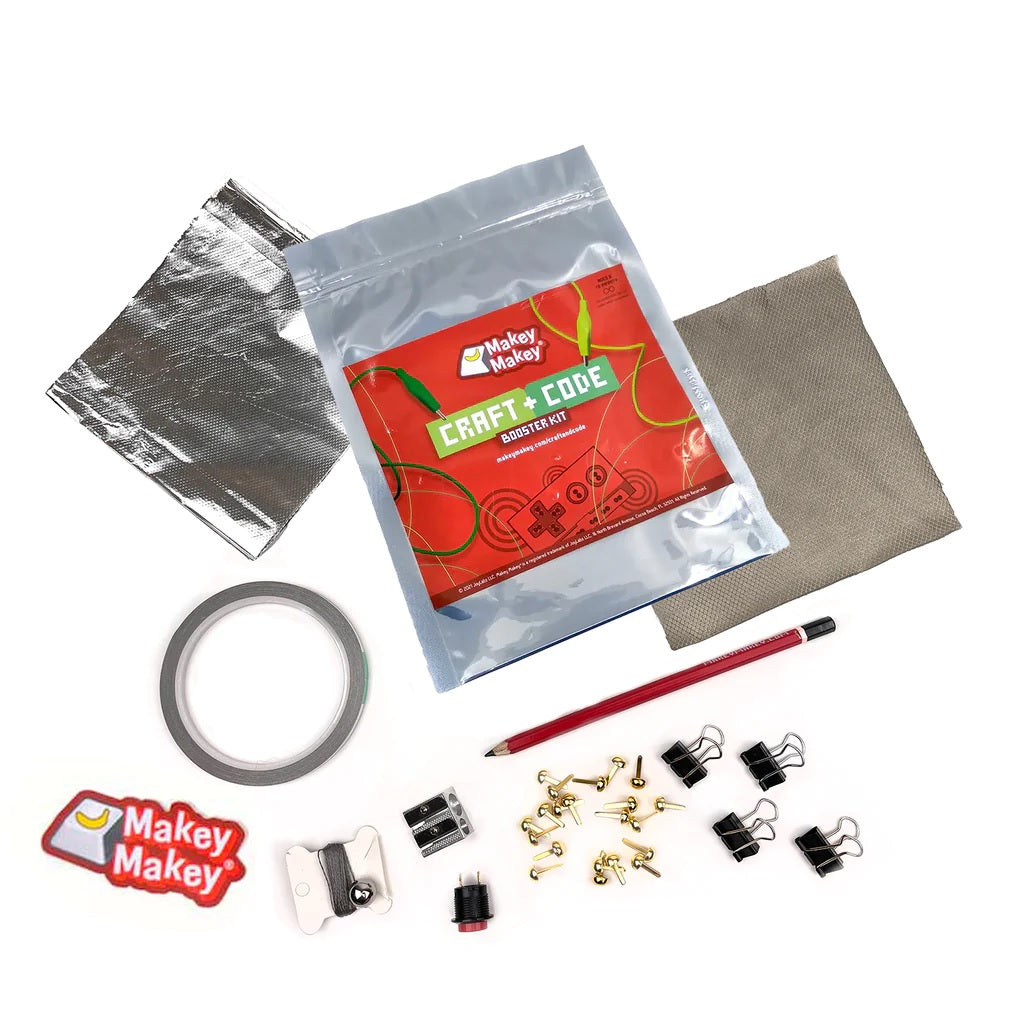 Makey Makey Craft + Code Booster Kit contents spread out on a table