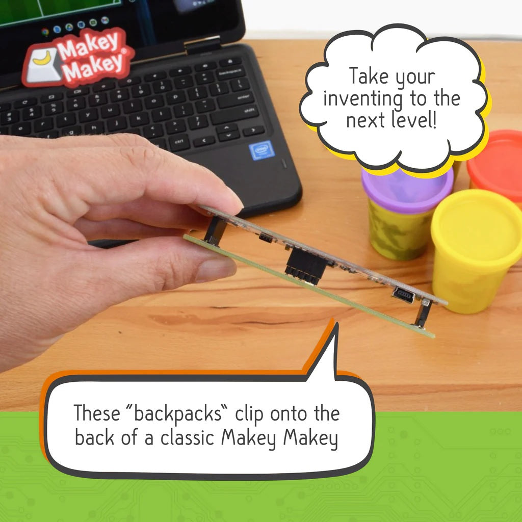 "Interactive Makey Makey Board with Backpack Attached" - Close-up of a Makey Makey board with one of the backpack attachments.